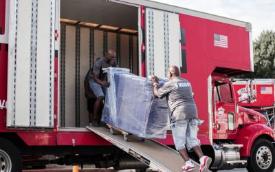 Two-men-moving-furniture-up-ramp-into-moving-truck-resized